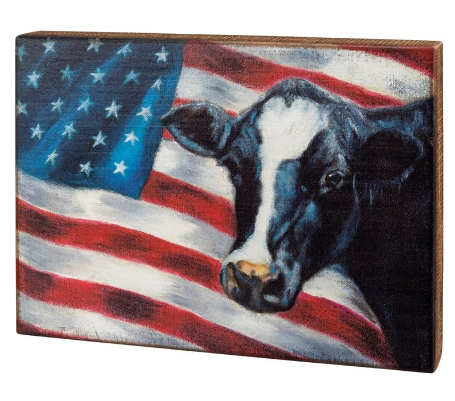 American flag with cow box sign