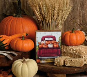 Red truck with pumpkins block sign